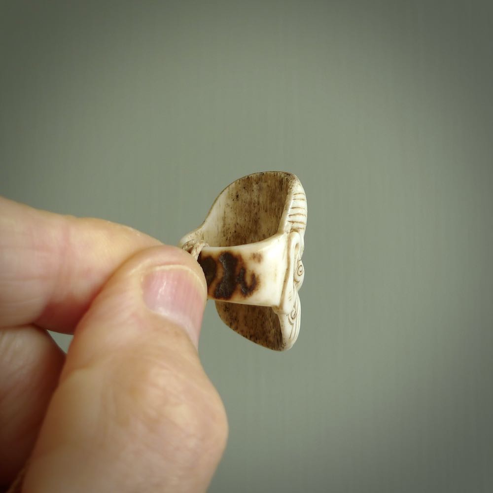 Hand carved Moko man face ring. Made from Red Deer antler in New Zealand. Unique Moko Man ring hand made from deer antler by master bone carver Fumio Noguchi. Spectacular collectable work of art, made to wear. One only ring, delivered to you at no extra cost with express courier.