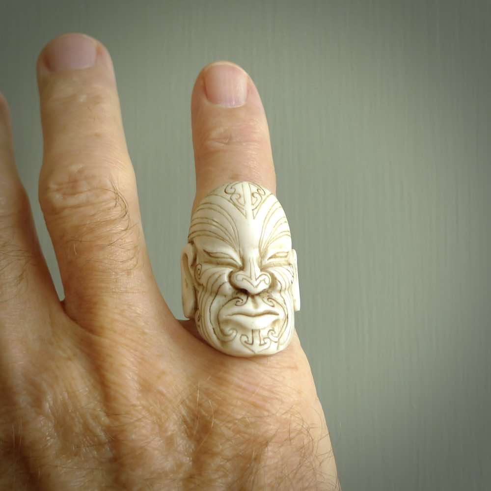 Hand carved Moko man face ring. Made from Red Deer antler in New Zealand. Unique Moko Man ring hand made from deer antler by master bone carver Fumio Noguchi. Spectacular collectable work of art, made to wear. One only ring, delivered to you at no extra cost with express courier.