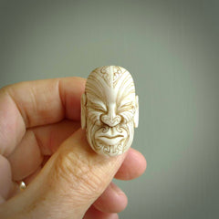 Hand carved Moko man face ring. Made from Red Deer antler in New Zealand. Unique Moko Man ring hand made from deer antler by master bone carver Fumio Noguchi. Spectacular collectable work of art, made to wear. One only ring, delivered to you at no extra cost with express courier.