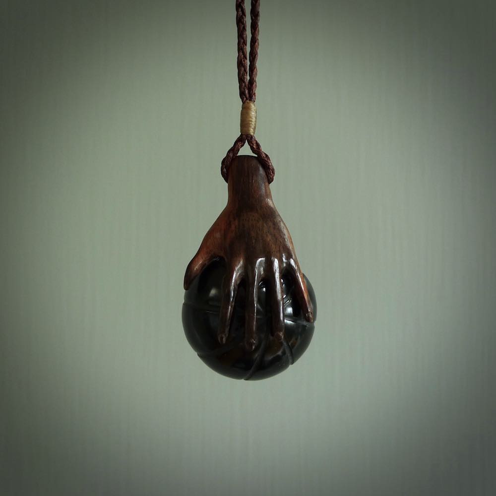 This is a very cool pendant that we've had carved for all you Basketball fans. The DUNK is a pendant with a woolly mammoth tusk hand holding a black jade basketball. We provide this on an adjustable black cord, and we ship worldwide. A very cool pendant, different, edgy and very wearable.