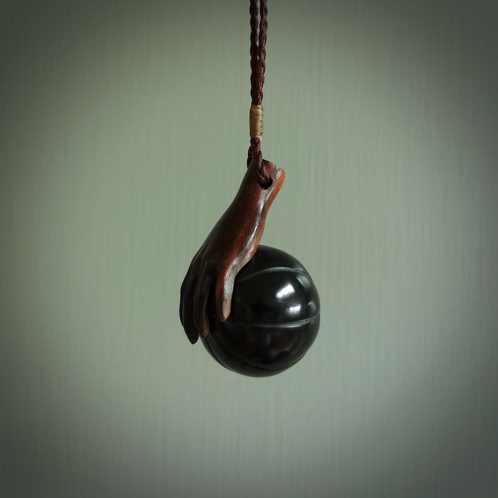 This is a very cool pendant that we've had carved for all you Basketball fans. The DUNK is a pendant with a woolly mammoth tusk hand holding a black jade basketball. We provide this on an adjustable black cord, and we ship worldwide. A very cool pendant, different, edgy and very wearable.