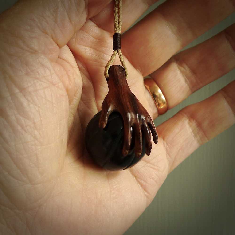 This is a very cool pendant that we've had carved for all you Basketball fans. The DUNK is a pendant with a woolly mammoth tusk hand holding a black jade basketball. We provide this on an adjustable black cord, and we ship worldwide. A very cool pendant, different, edgy and very wearable.