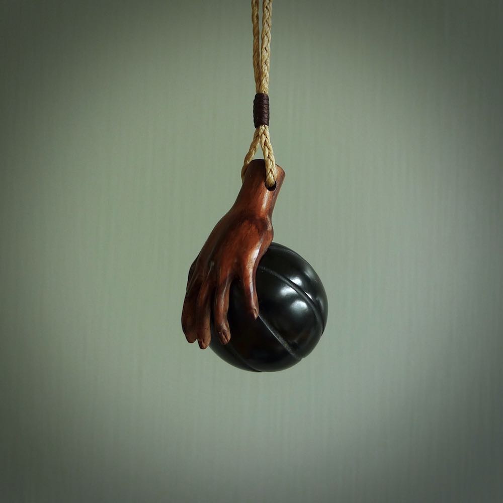 This is a very cool pendant that we've had carved for all you Basketball fans. The DUNK is a pendant with a woolly mammoth tusk hand holding a black jade basketball. We provide this on an adjustable black cord, and we ship worldwide. A very cool pendant, different, edgy and very wearable.