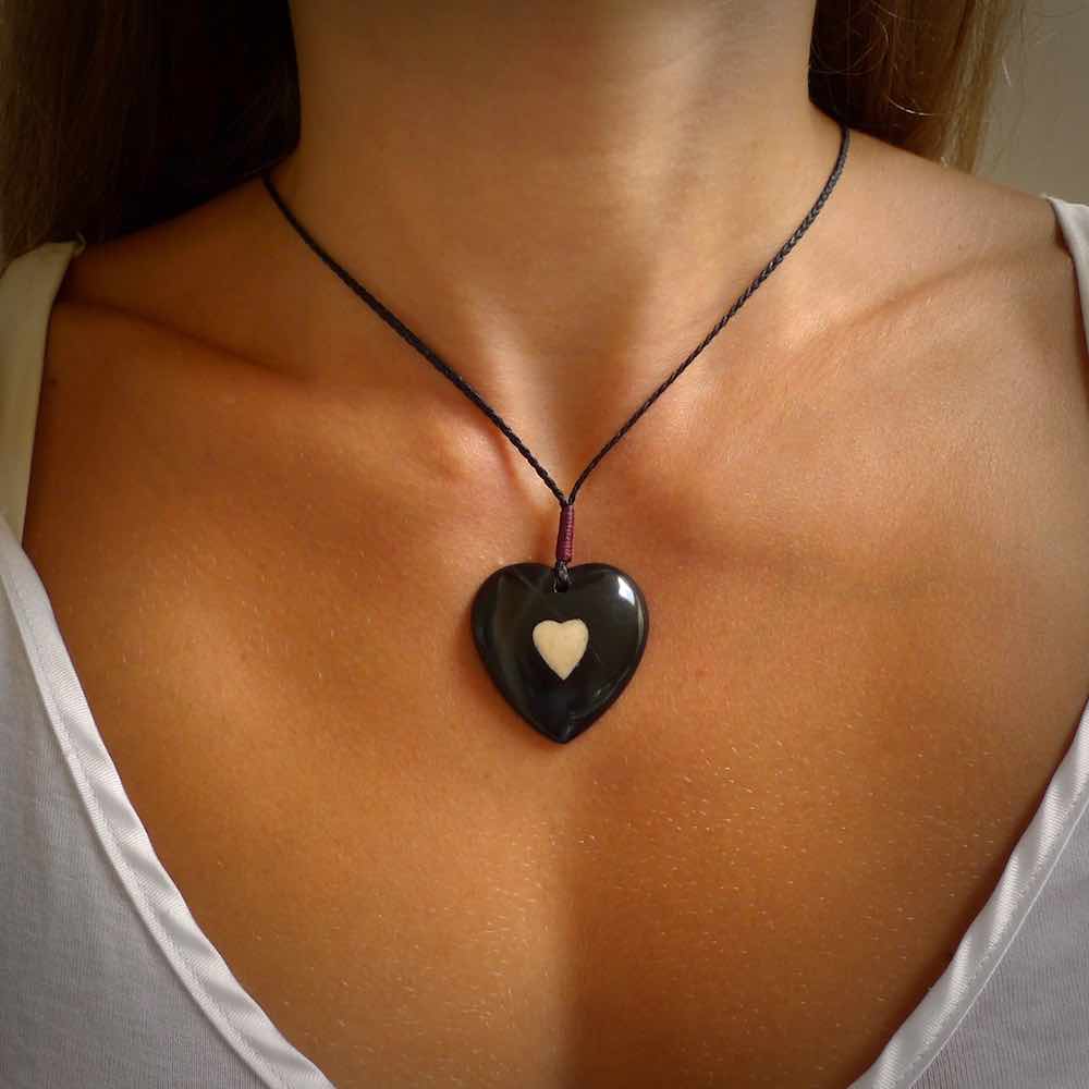 Hand carved black jade heart. Made from Australian black jade. White heart insert is carved from natural bone material. Made by NZ Pacific.