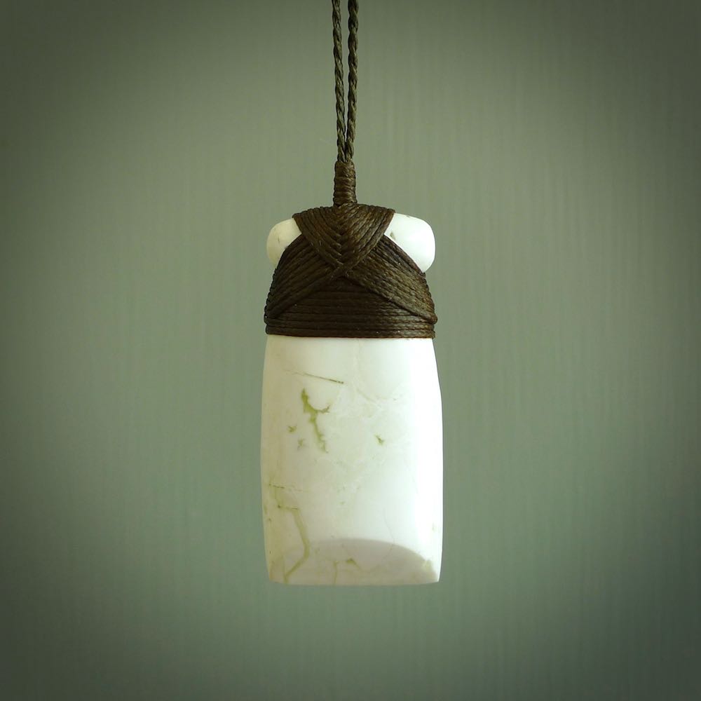 This pendant is a lovely toki carved from white onyx stone. It is a traditional shape and is traditionally bound but carved from a striking white stone. A beautiful piece of handmade jewellery from NZ Pacific.