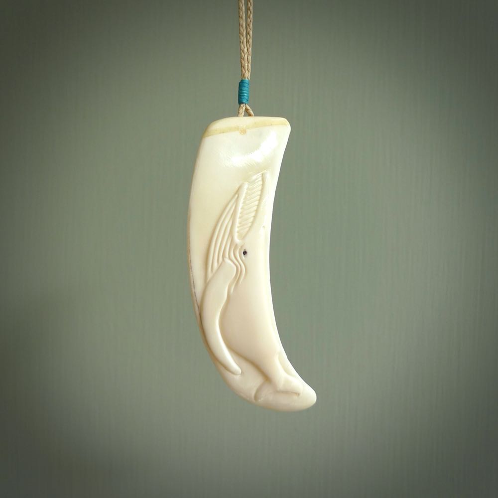 Hand carved whale pendant, carved by us. This piece is carved from boars tusk and is a fantastic depiction of these giants of the deep. This particular piece is a Blue whale design and is lovingly carved.