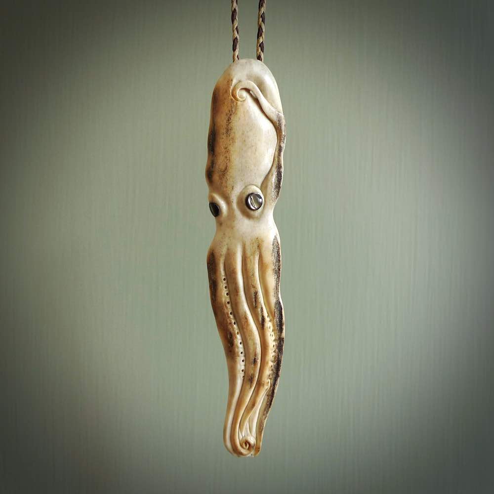 Hand carved octopus pendant. This piece has been carved in minute detail from deer antler. The artist is Fumio Noguchi, a renowned New Zealand bone carver who carves pieces for NZ Pacific. These unique bone pendants are for sale online at nzpacific.com One only collectors item for lovers of the ocean and octopus.