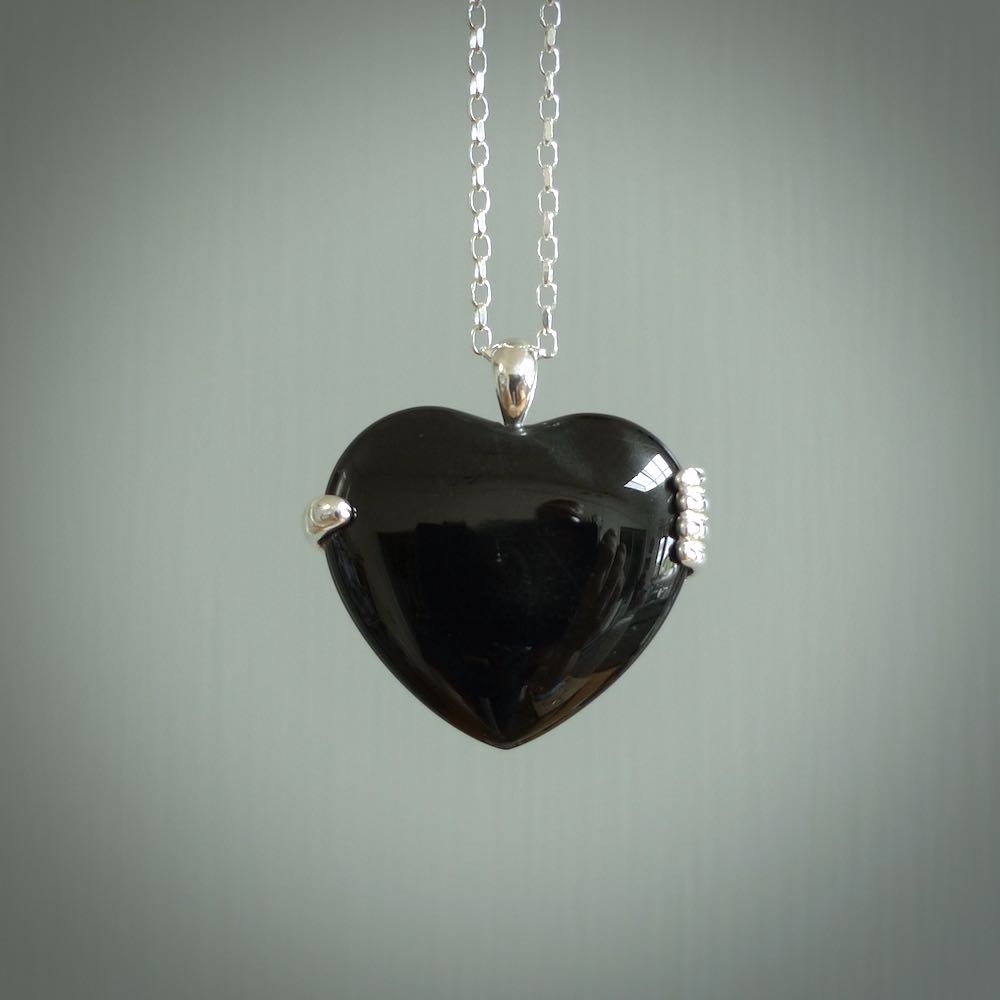 Hand crafted Australian Black jade heart in sterling silver hand necklace. This piece has a sterling silver hand holding a Black Jade heart. This necklace is provided with a sterling silver chain.