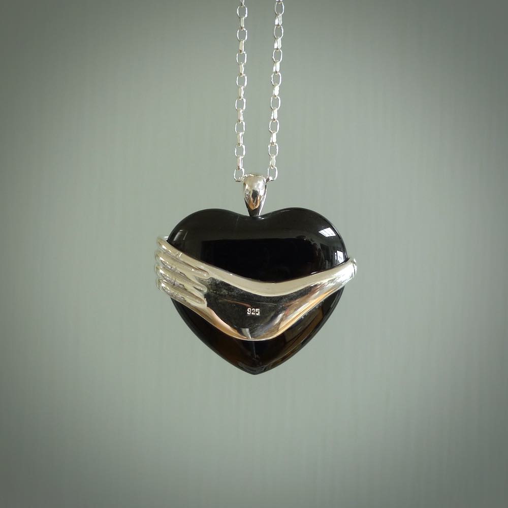 Hand crafted Australian Black jade heart in sterling silver hand necklace. This piece has a sterling silver hand holding a Black Jade heart. This necklace is provided with a sterling silver chain.