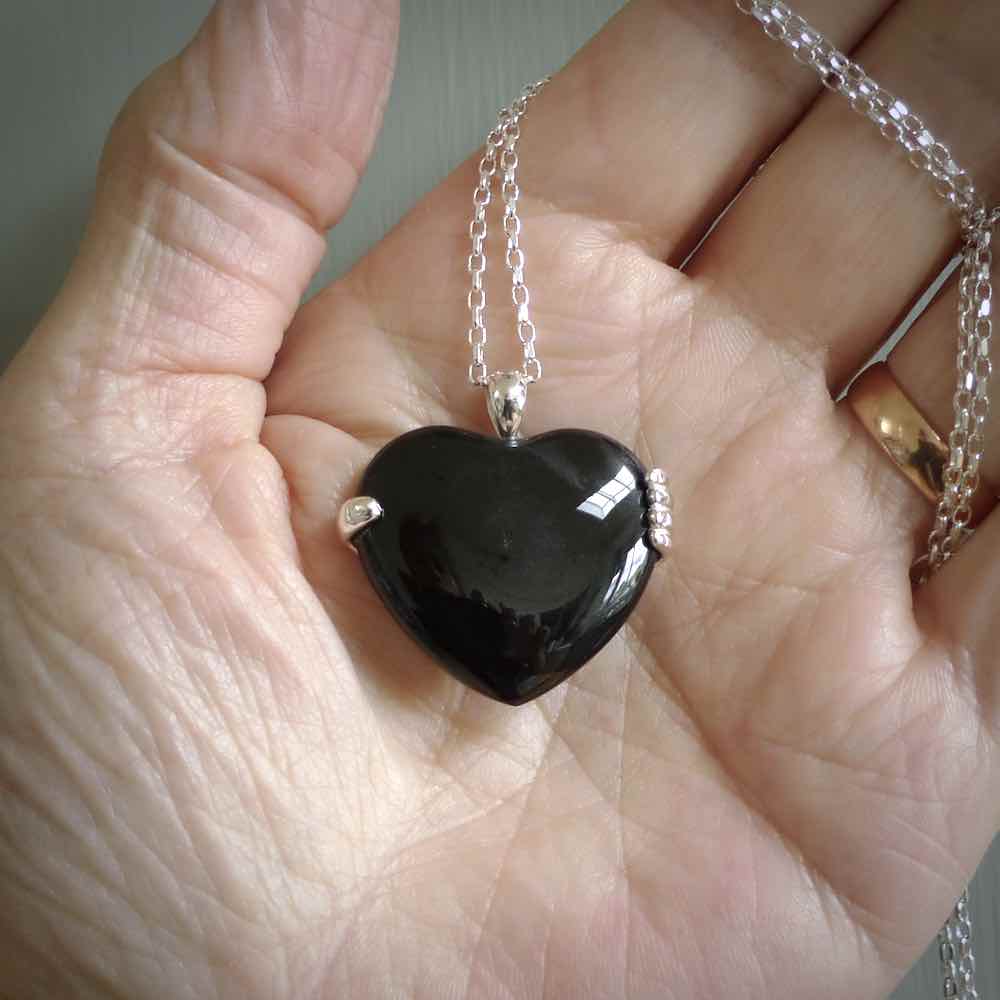 Hand crafted Australian Black jade heart in sterling silver hand necklace. This piece has a sterling silver hand holding a Black Jade heart. This necklace is provided with a sterling silver chain.