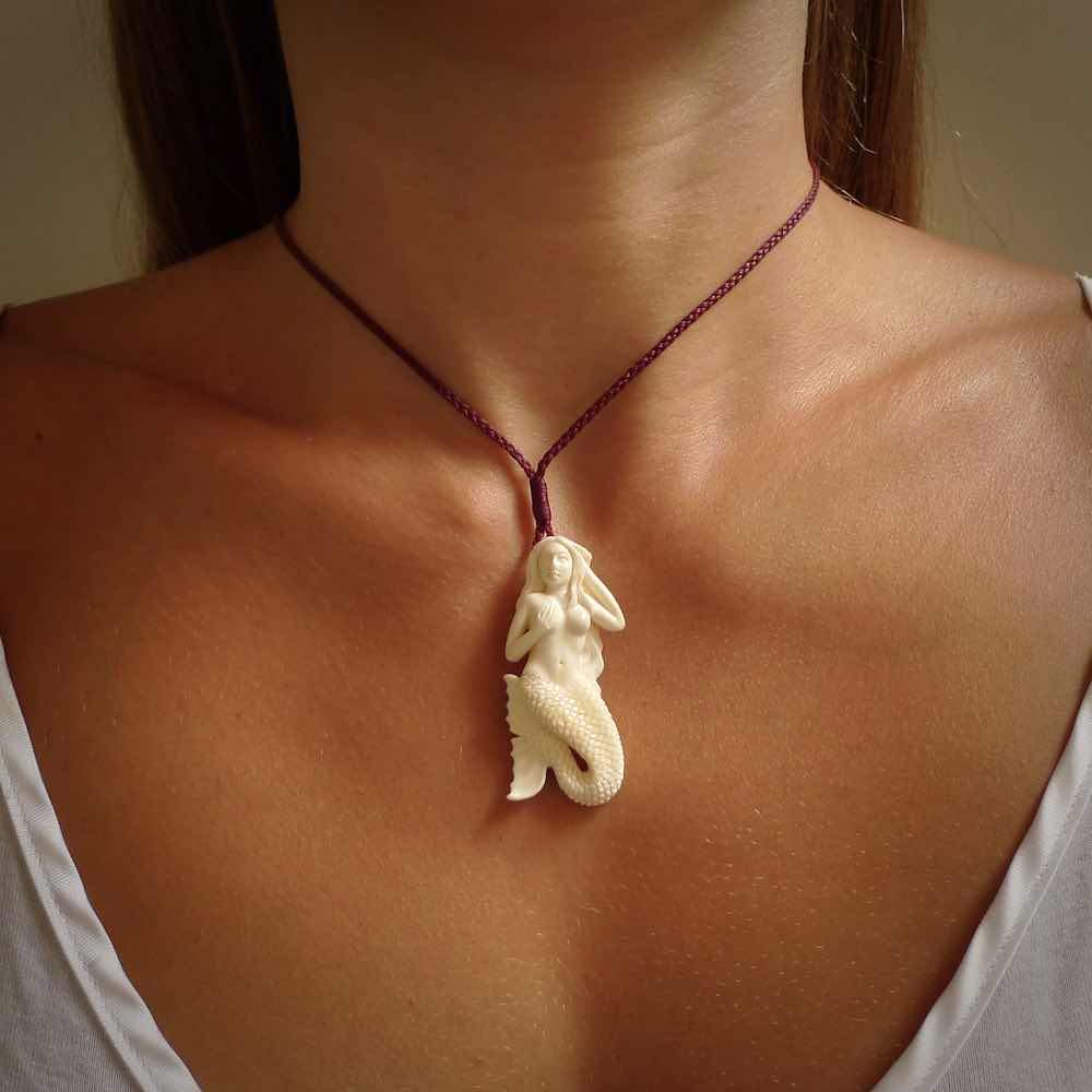 Hand carved natural bone mermaid pendant. Hand made from real bone. Art to wear.